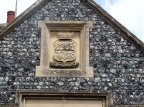Going through the little village of Boughton Leed, I see this crest on an old house but cannot read it.